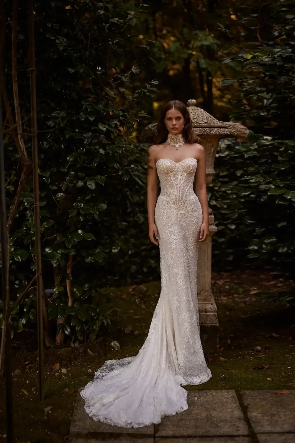 model is wearing a strapless lace bridal gown