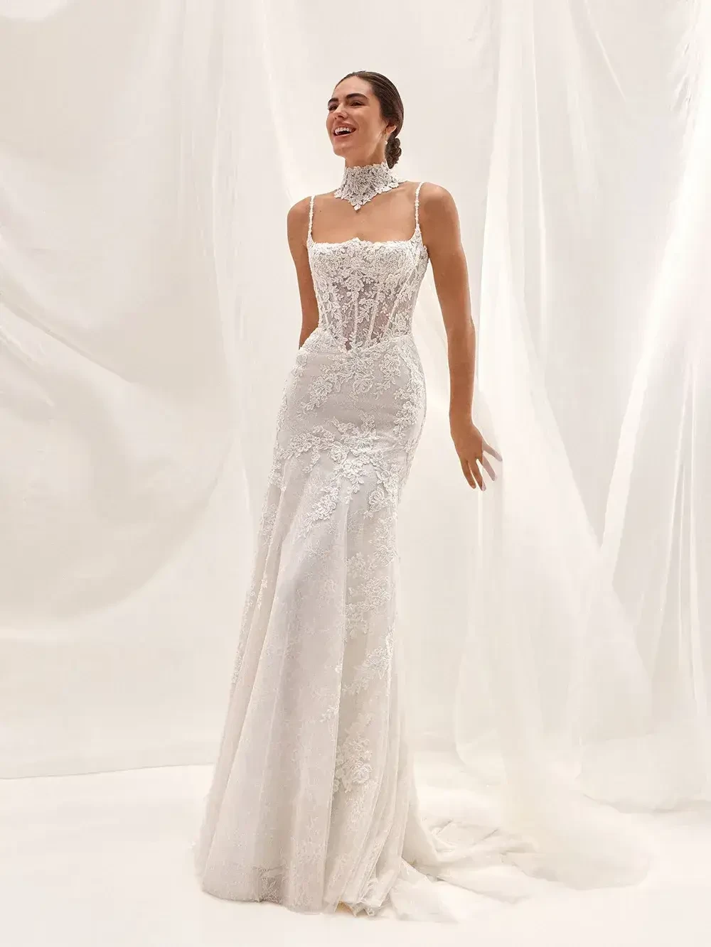 model is wearing a strapless lace sheath bridal gown