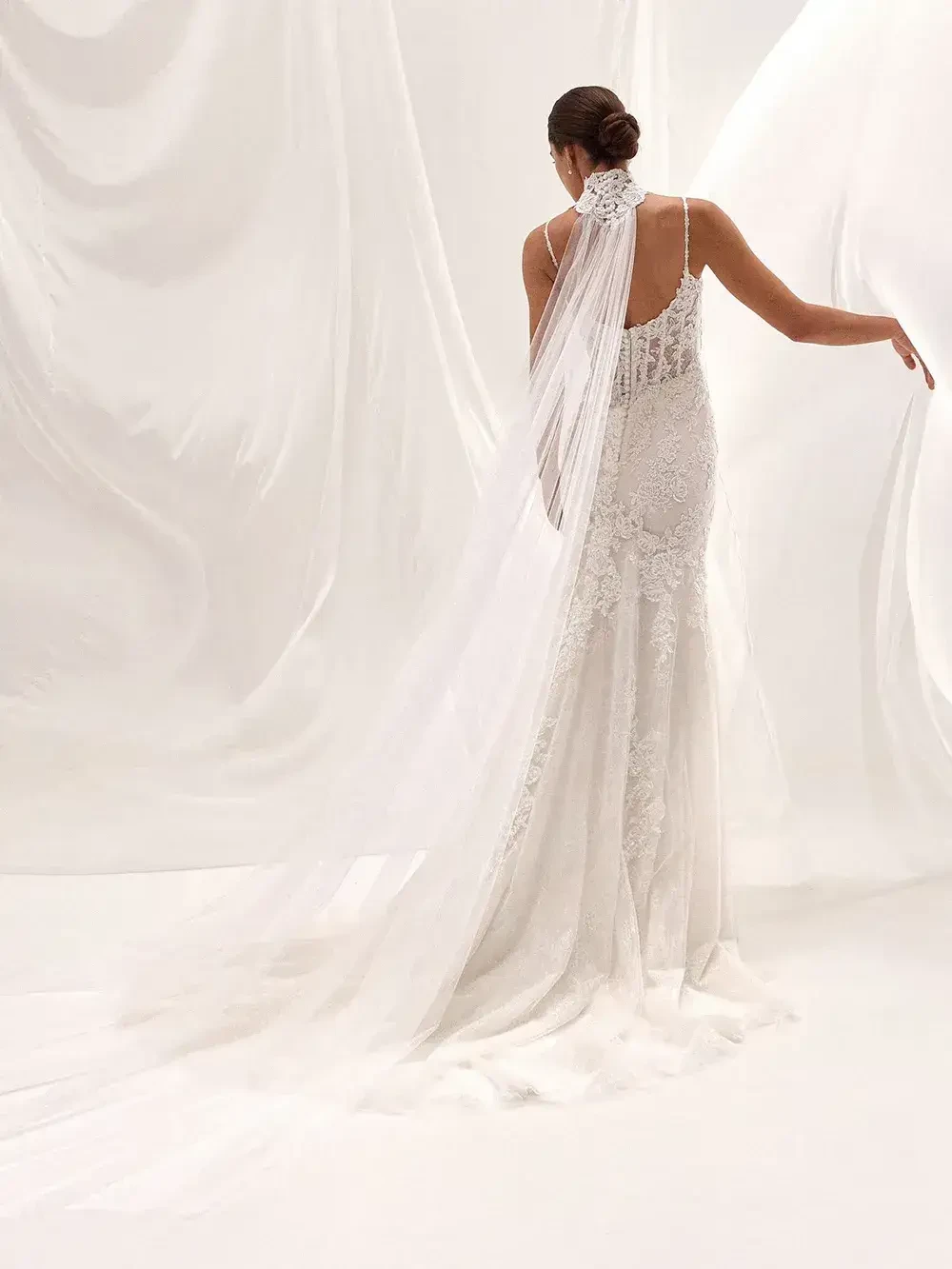 model is wearing a strapless lace sheath bridal gown