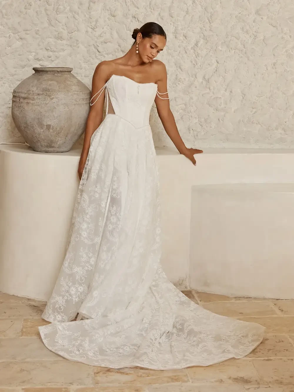model is wearing a strapless a-line bridal gown
